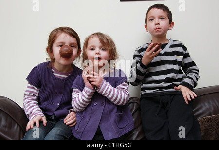 Children eating chocolate Easter Eggs, UK Stock Photo