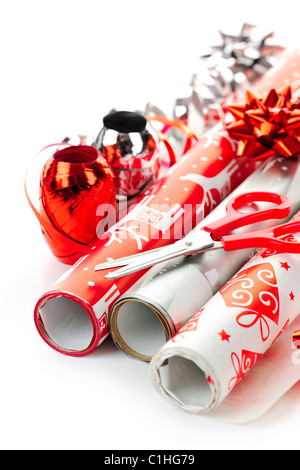 Rolls of Christmas wrapping paper with ribbons, bows and scissors Stock Photo