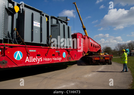 Unloading Alstom National Grid Electrical Transformer, Preston from the barge Terra Marique on the River Ribble, Lancashire, UK Stock Photo