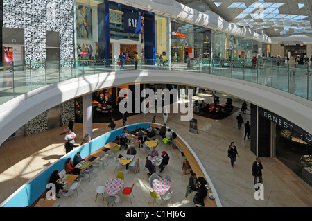 Looking down on shoppers interior of London shopping mall at Westfield shopping centre Shepherds Bush White City London England UK Stock Photo