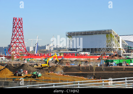 Anish Kapoor 2012 London Olympic Orbit sculpture tower under construction & temporary stand building at Aquatics swimming centre Stratford England UK Stock Photo