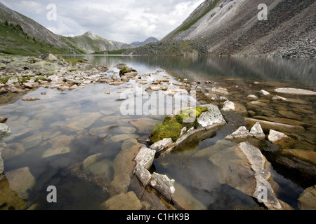 Mountain lake with stones in transparent water. Eastern Sayan mountains. Siberia. Buryat republic. Russia. Stock Photo