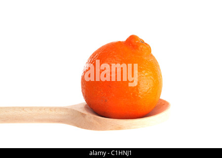 Tangelo on a wooden spoon isolated against a white background Stock Photo