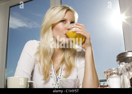Woman drinking orange juice Stock Photo