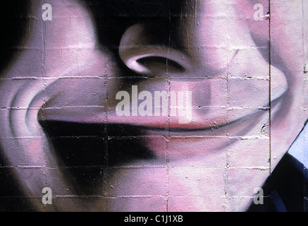 Happiness is... Close up on a Contented Smile Painted on Brick Wall, Barcelona, Spain Stock Photo