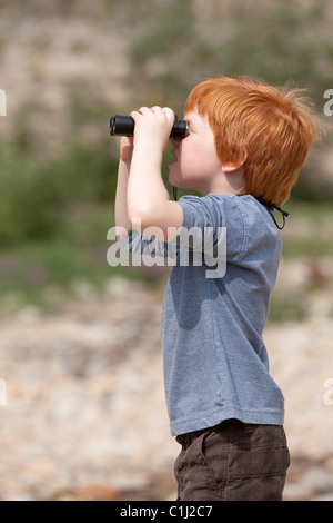 Boy Looking through Binoculars, Jasper National Park, Alberta, Canada Stock Photo