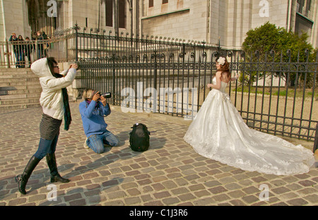 A bride is photographed outside a church in Paris. Stock Photo