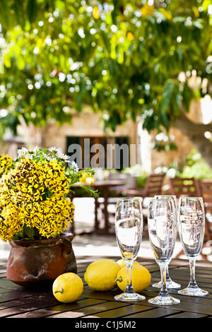 Close-up of Champagne Glasses and Lemons on Table, Majorca, Spain Stock Photo