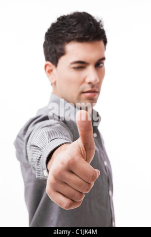 Handsome young man with thumbs up on an isolated white background, focus is on the hand Stock Photo