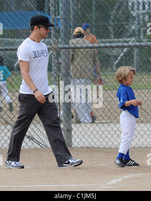 Ryan Phillippe and Deacon Reese Phillippe  Ryan Phillippe watches his son's baseball game with his girlfriend and daughter Los Stock Photo