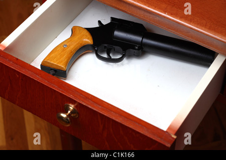 Flare gun forgotten in old desk drawer Stock Photo