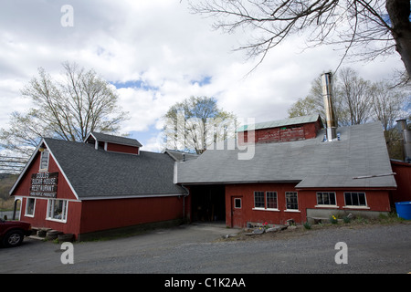 A New England sugar maple business has a restaurant as well as the sugar shed with tall stainless steel smoke stack. Stock Photo