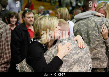 Family members hug soldiers during a deployment ceremony for the Bedford, Ind. based 2219th Brigade Support Company of the India Stock Photo