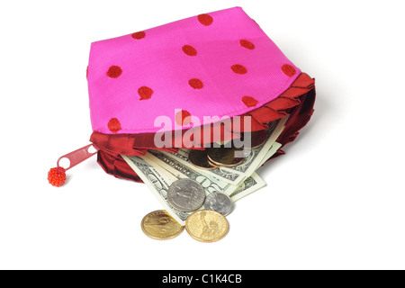 US notes and coins spilling out from pink purse on white background Stock Photo