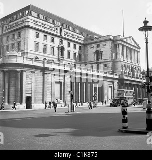 1950s, the exterior of the Bank of England on Threadneedle Street, City of London, with people and vehicles of the day, including a routemaster bus. Stock Photo