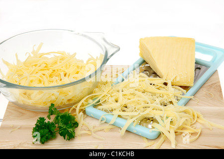 Grated cheese on a wooden cutting board - high key image Stock Photo