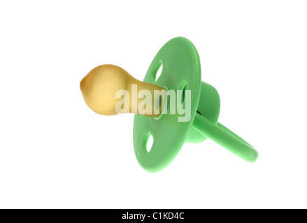 High key image of a traditional infants green dummy or pacifier taken against a white background. Stock Photo