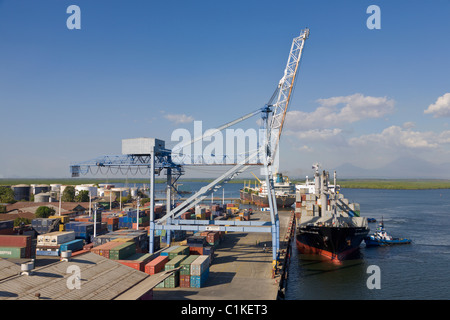 Container ship with tug arriving at the Port of Corinto, Nicaragua Stock Photo