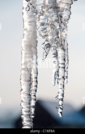 icicles frozen hanging off guttering on a suburban house Stock Photo