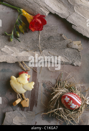 Greeting card - egg in a nest on bark background Stock Photo