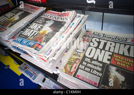 Headlines of New York newspapers on a news stand on the Operation Odyssey Dawn in Libya Stock Photo