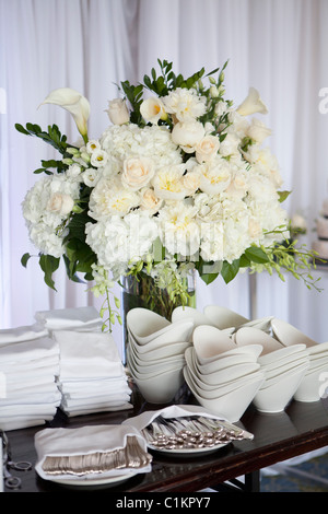 Utensils, Dishes and Flowers at Wedding Reception Stock Photo