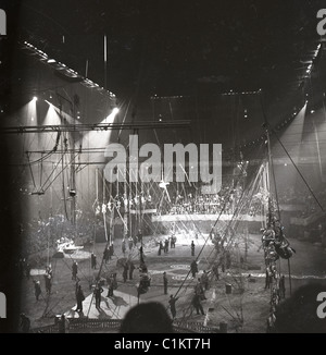 Circus performers in black and white photo inside huge arena tent big top Stock Photo
