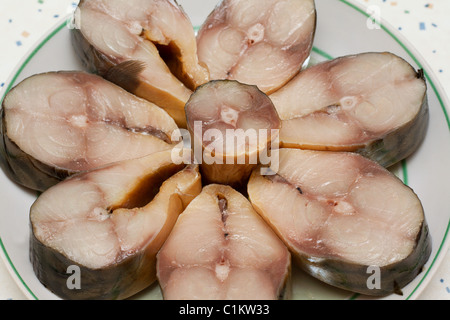 Bit smoked mackerel put on plate on kitchen Stock Photo