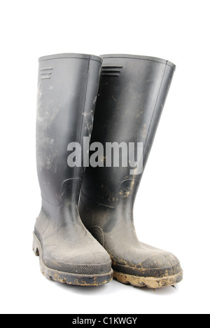 Black rubber boots and soil on white Stock Photo