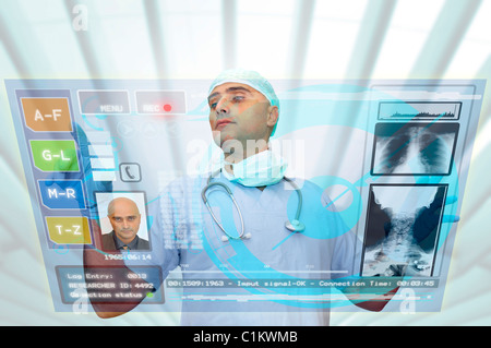 Doctor with high-tech computer screen viewing patient data Stock Photo