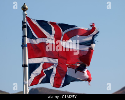Union Jack flag flapping in the wind against a blue sky Stock Photo - Alamy