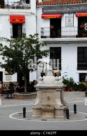 Village square with fountain and cafes to rear, Casares, Cadiz Province, Andalucia, Spain, Western Europe. Stock Photo