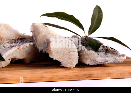 View of a bunch of sliced salted codfish isolated on a white background. Stock Photo