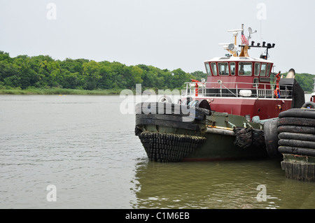 Tugboat sits in the Savannah River on a dreary and overcast day in Savannah, Georgia. Stock Photo