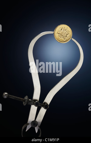Pound Coin with Calipers Stock Photo