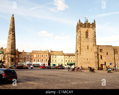 Holy Trinity Church and the octagonal sandstone obelisk rebuilt 1771 in the Market Place Richmond North Yorkshire UK Stock Photo