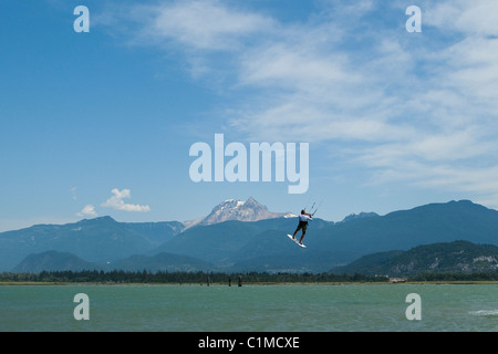 A kiteboarde is airborne at 'the Spit',Squamish, BC, Canada Stock Photo