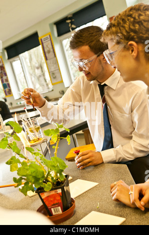 Two sixth form Pupils doing an experiment in a A level biology science practical class in a secondary school UK Stock Photo