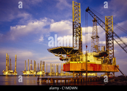 Idle offshore oil platforms being serviced before use in Sabine Pass, Texas, USA Stock Photo