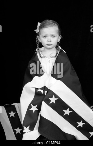 A girl clothed in an American flag design. The photograph is in black and white. Stock Photo