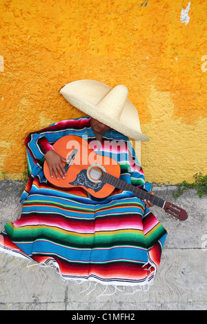 Mexican typical lazy man sombrero hat guitar serape nap siesta Stock Photo