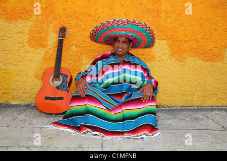 Happy mexican sit man typical sombrero hat colorful serape guitar  Stock Photo