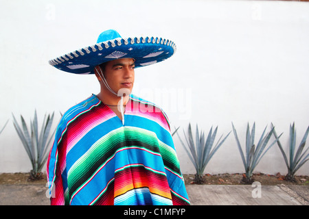 handsome mexican man charro sombrero serape agave cactus Stock Photo