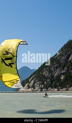 A kiteboarder catches the wind at 'the Spit' in Squamish, BC Stock Photo