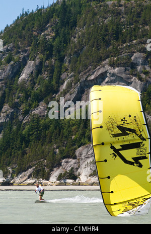 A kiteboarder catches the wind at 'the Spit' in Squamish, BC Stock Photo