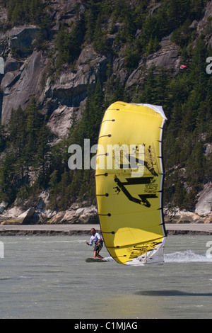 A kiteboarder catches the wind at 'the Spit' in Squamish, BC Stock Photo