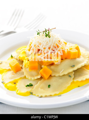 Gourmet squash ravioli dinner served with cheese on plate