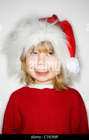 Girl wearing santa hat, looking up