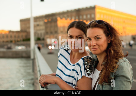 Two women standing on bridge Stock Photo
