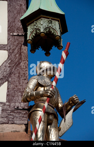 Germany, Bavaria, Nuremberg. Typical half-timbered architecture near Market Square, knight in armor. Stock Photo